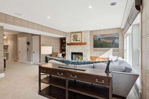 Lower level family room in anchored by a wood burning fireplace with beautiful stone.