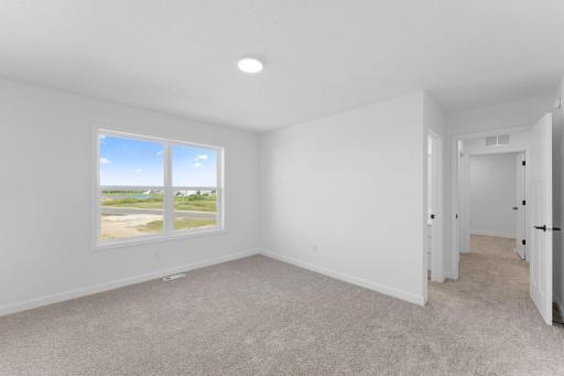 Three secondary bedrooms are situated down the hall from the ownerâs suite on the second floor.