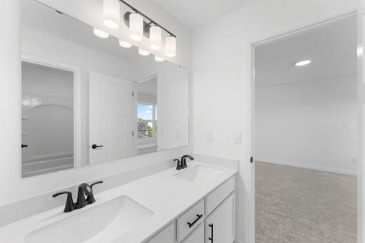 This Jack-and-Jill bathroom connects two bedrooms on the second floor, with dual sinks to accommodate shared living.