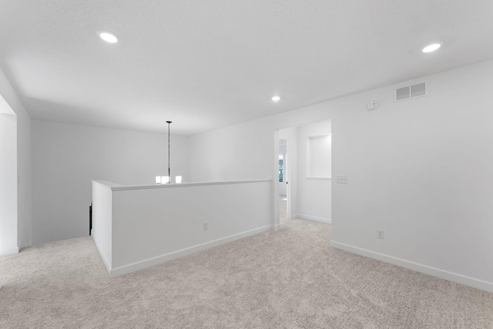 A versatile loft can be found at the top of the stairs, offering a shared living area that everyone can enjoy.