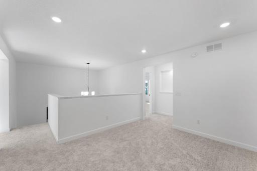 A versatile loft can be found at the top of the stairs, offering a shared living area that everyone can enjoy.