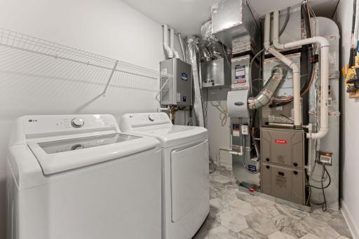 (Photo of a similar home, actual finishes may vary) The laundry room features ventilated shelving for your storage needs