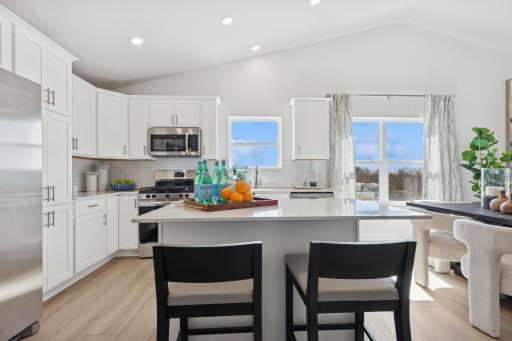 (Photo of decorated model, actual home's finishes will vary) High ceilings create a dramatic impact in the main level, and there are tons of windows bringing in natural light!
