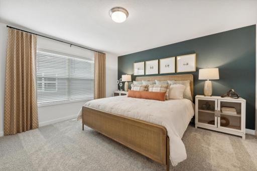 (Photo of decorated model, actual home's finishes will vary) Extremely spacious and elegant, this private owner's suite connects to a large en-suite bath providing a great oasis to relax in your own private space.