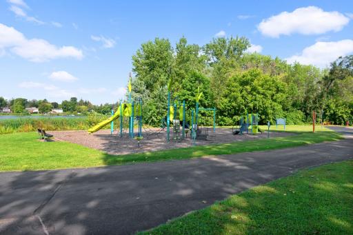 Modern playground and lakeside park create a wonderful outdoor space for recreation and relaxation.