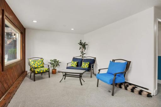 Bright indoor pool seating area offering year-round comfort just steps from the community pool.