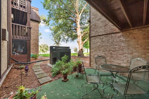 Enjoy peaceful views from your private ground-level patio with direct access to beautifully landscaped community green space.