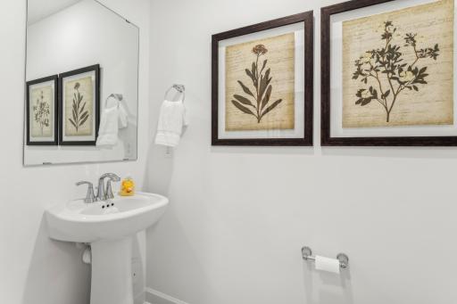 (Photo of a model home, actual homes finishes will vary) Half bath conveniently located on the main floor!