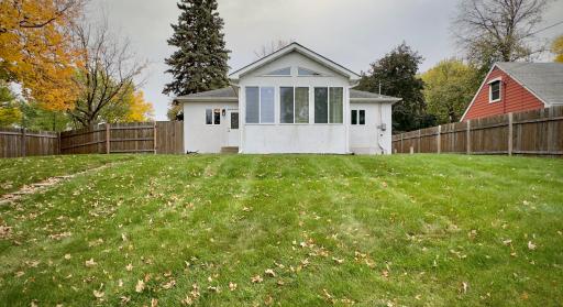 The 4 season porch is perched overlooking the spacious backyard