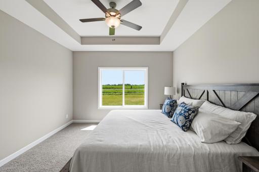 Primary bedroom - photos are of a staged home with same floorplan. Colors and selections may differ.