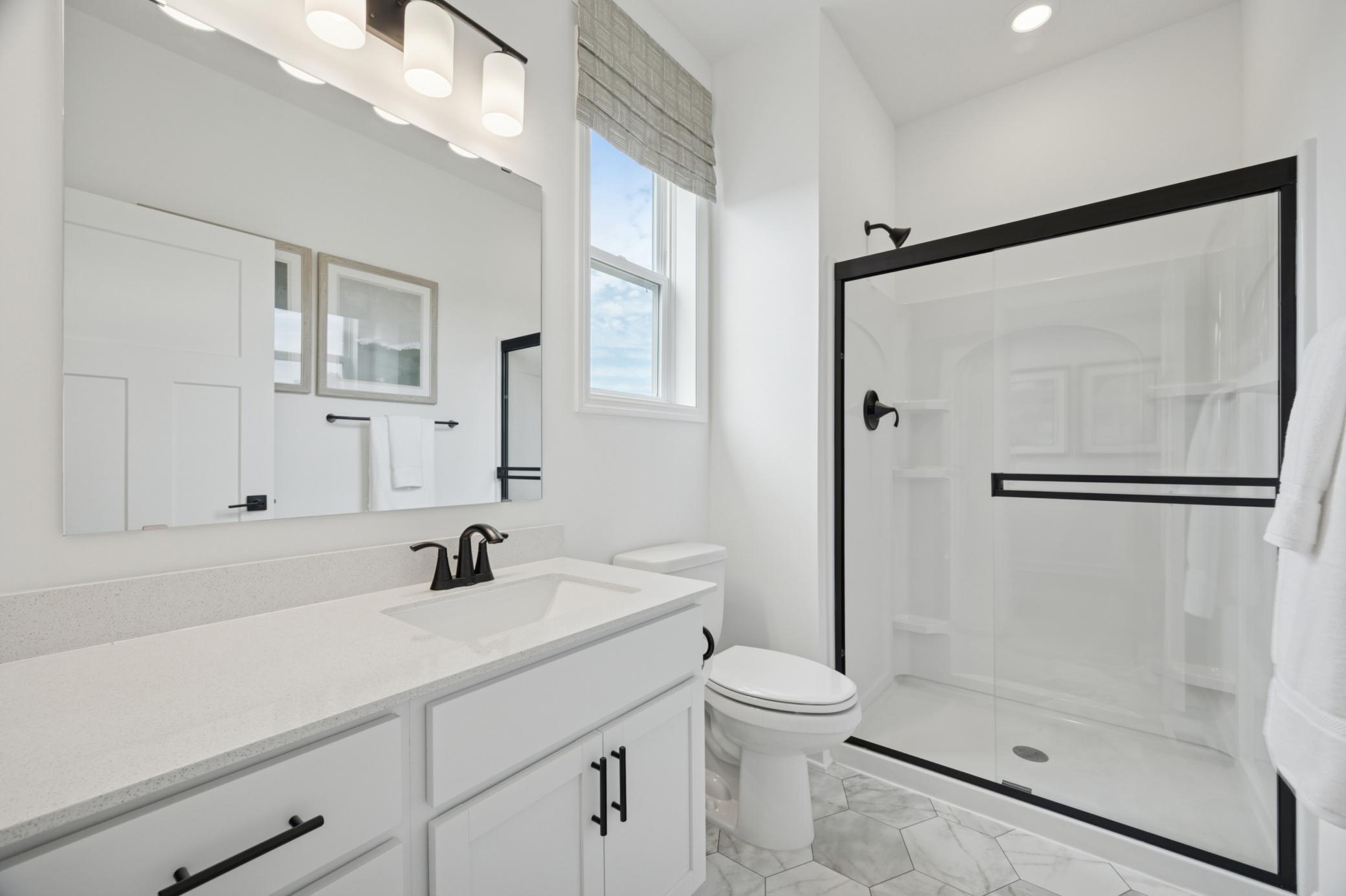 (Photo of a decorated model, actual homes finishes will vary) The main level bath.
