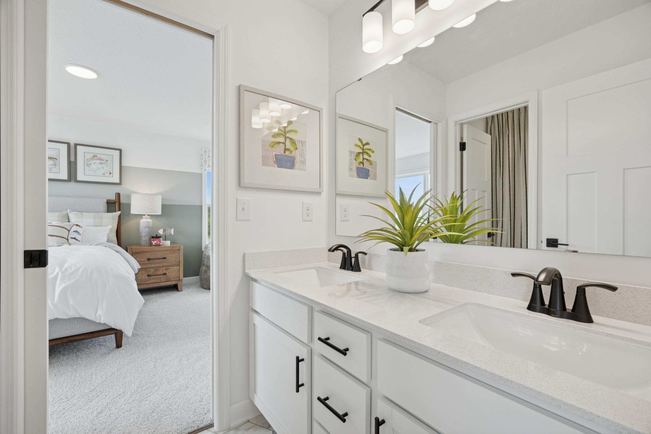 (Photo of a decorated model, actual homes finishes will vary) This Jack and Jill bath connects two of the secondary bedrooms.