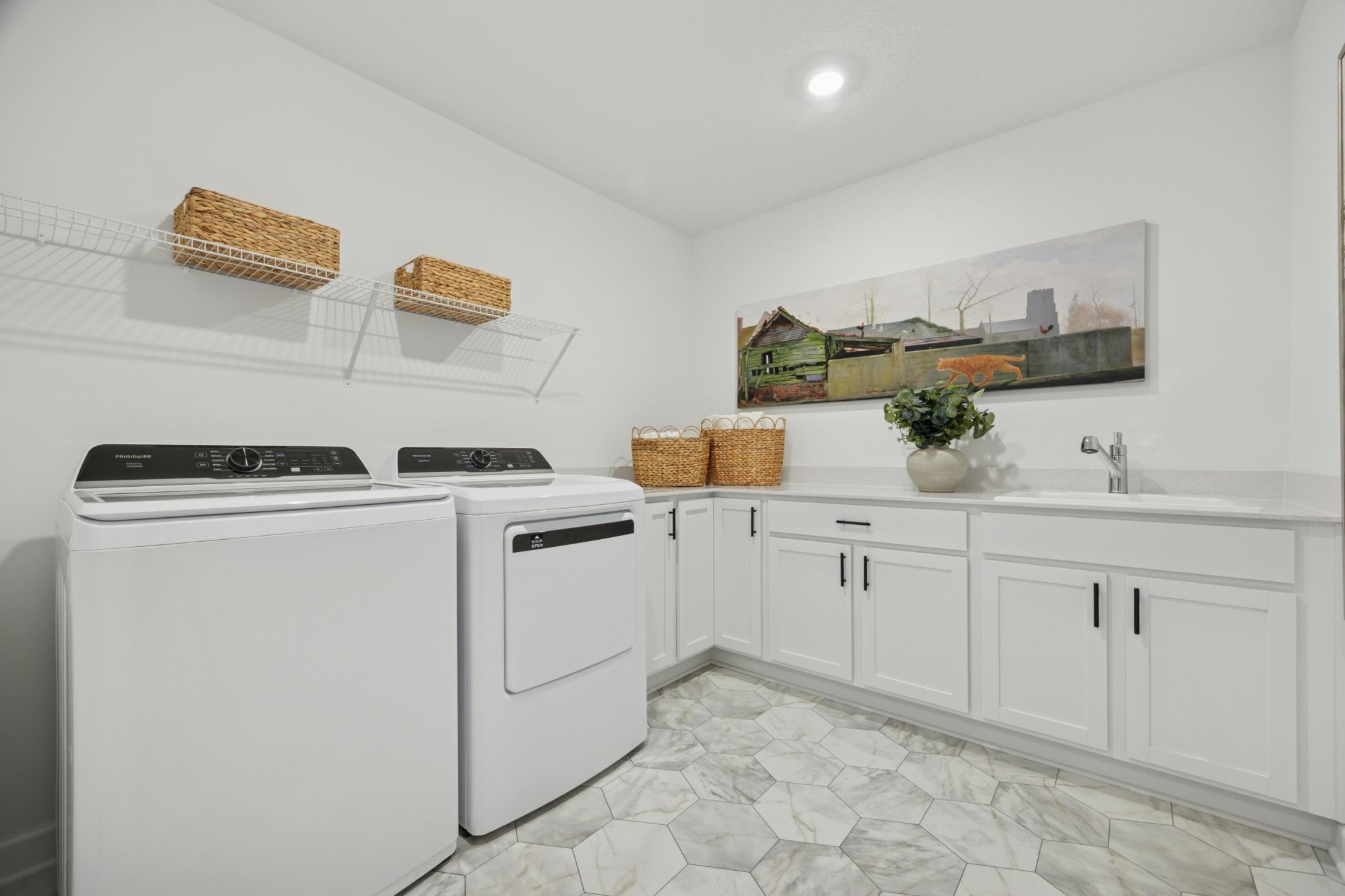 (Photo of a decorated model, actual homes finishes will vary) The upper-level laundry room.