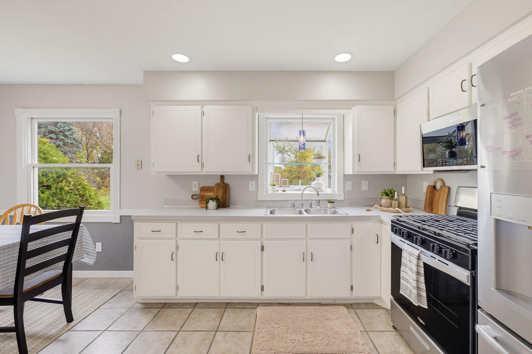 Kitchen with Painted Cabinets, Stainless Steel Appliances & Beautiful Backyard Views
