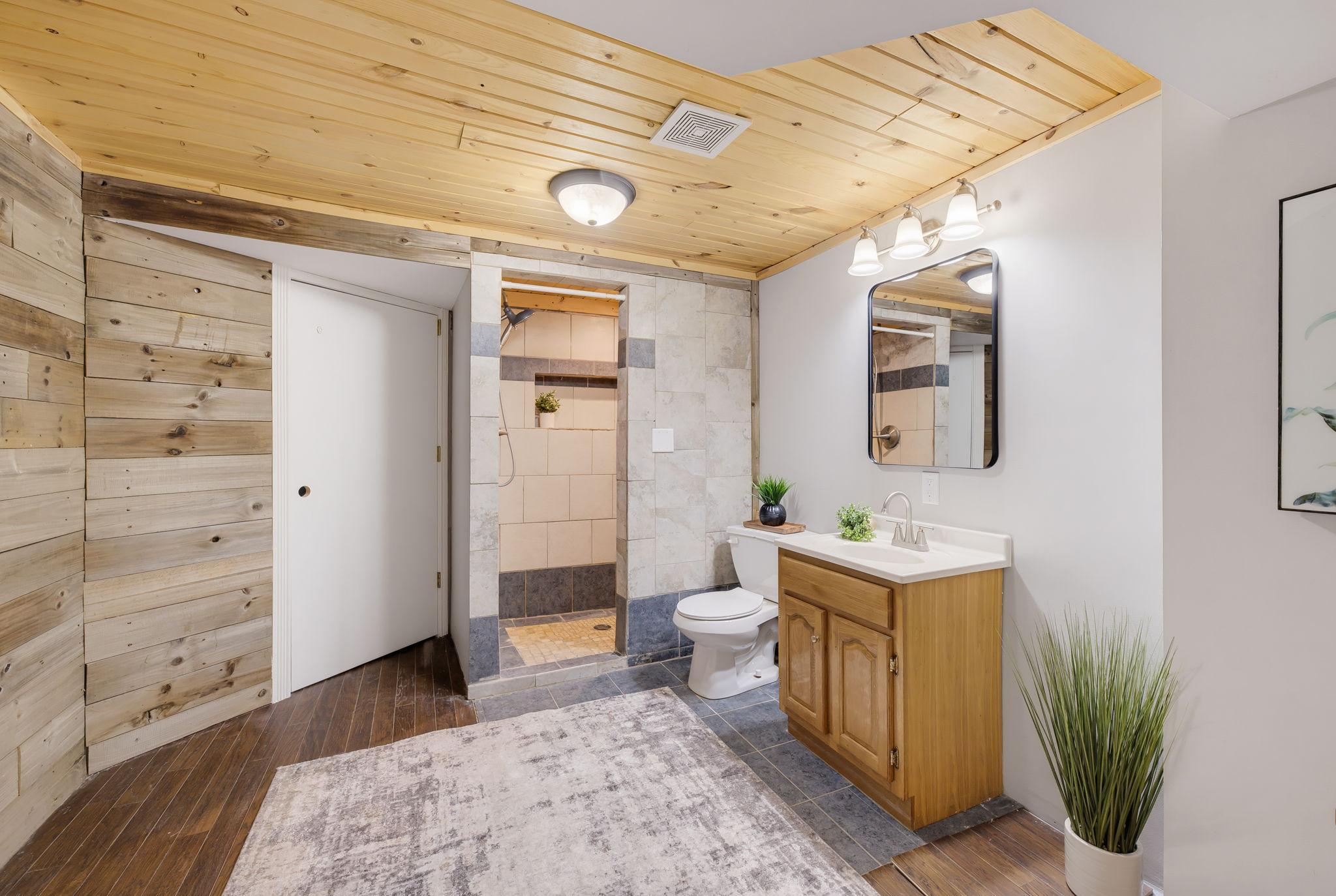 Large Basement Bathroom with Access to Storage Under the Stairs