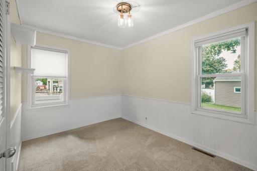 Another angle of the third bedroom highlights the natural light from two windows, making this a bright and comfortable space with plenty of flexibility.