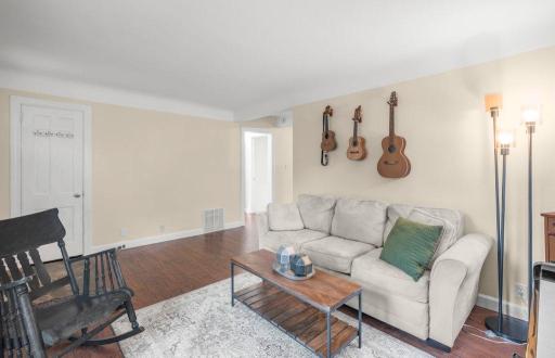 Another view of the living room shows just how flexible the space is, with plenty of room to arrange seating for conversation, entertaining, or simply relaxing at home.