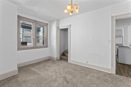Second duplex dining area with access to kitchen and staircase leading to upper level