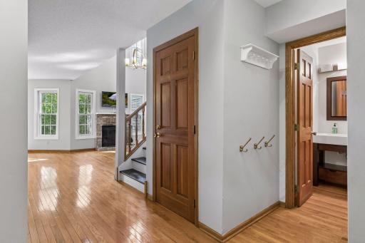 Foyer with 1/2 bathroom on right leading into living room