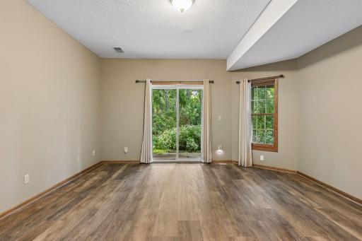 Lower level family w/ sliding glass door leading to patio