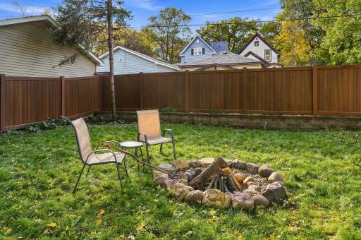 Fire pit and new $20,000 30 year mocha vinyl fence.