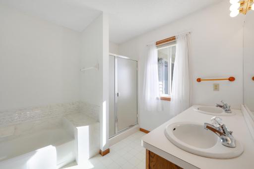 Enjoy a little extra breathing room in your private primary bath, with dual sinks for easier mornings, a separate shower and soaking tub, and a window that welcomes natural light