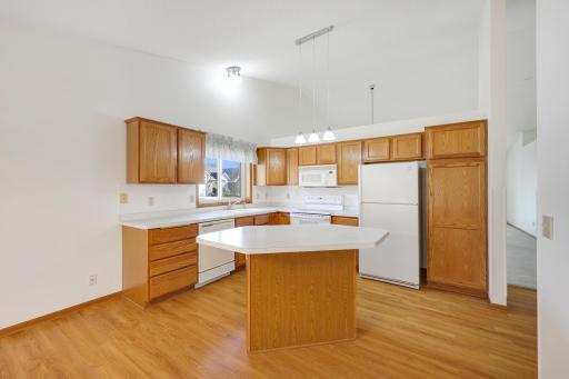 With cabinets and countertops surrounding the center island, this kitchen offers a practical layout that keeps everything close at hand