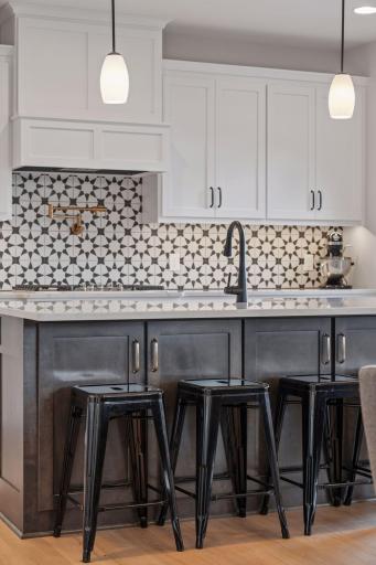 Stylish ceramic tile backsplash throughout the kitchen