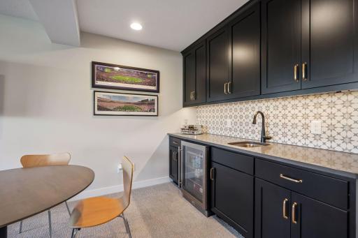 Wet bar with beverage fridge, sink, and counter/cabinet space