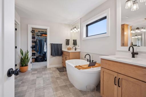 Two sinks, separate vanities, separate tub, separate shower, and walk-in closet