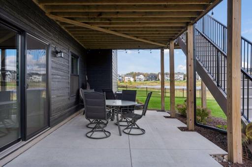 Walk out onto the covered concrete patio and views of the yard.