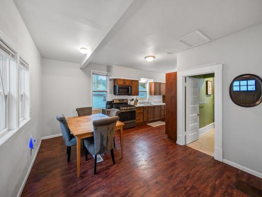 Open dining area conveniently connected to the kitchen, featuring hardwood floors and natural light.