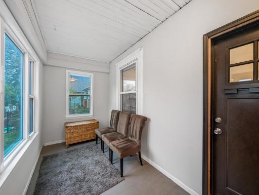 A bright and peaceful entryway that offers a warm welcome home, with natural light streaming through the windows.
