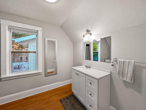 Natural light and warm wood flooring give this bathroom a fresh, welcoming feel.