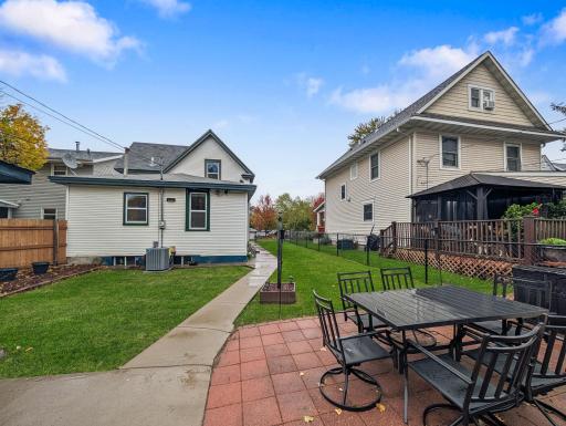 The backyard patio creates a great spot for outdoor dining, summer get-togethers, or simply enjoying a little fresh air.