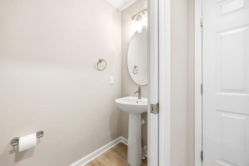 Main level powder room w/ slider pocket door.