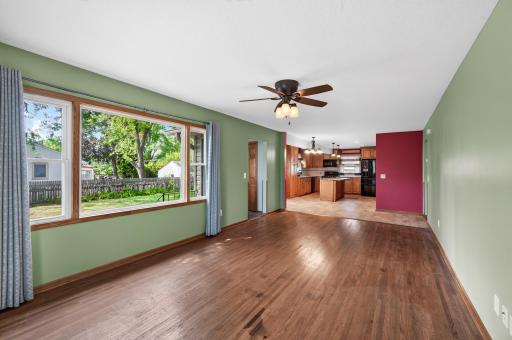 Wide open main living room area with natural hardwood flooring.