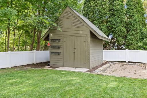 A spacious 12x10 storage shed provides additional storage and sits next to a sandbox that could easily be transformed into a flower bed or garden area.