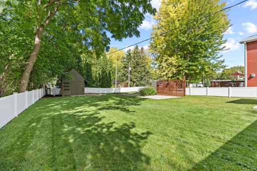 Two concrete patio areas provide plenty of room to relax, with one featuring a covered overhang and the other offering a privacy wall for added comfort.