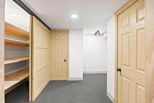 A 10x6 unfinished storage room with built-in shelving hall closet provides even more storage options.