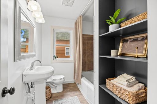 An updated full bathroom is conveniently located just steps from both bedrooms and features a single vanity, tub/shower combination, and linen storage.