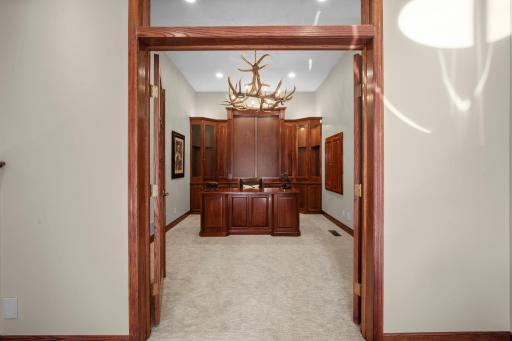 French doors open to this beautiful den with built-ins