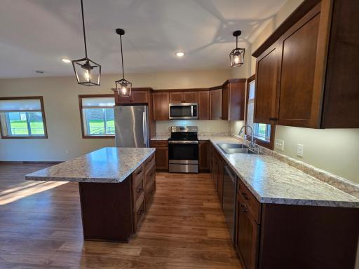 Well laid out kitchen has quality soft close cabinets and extra lighting.