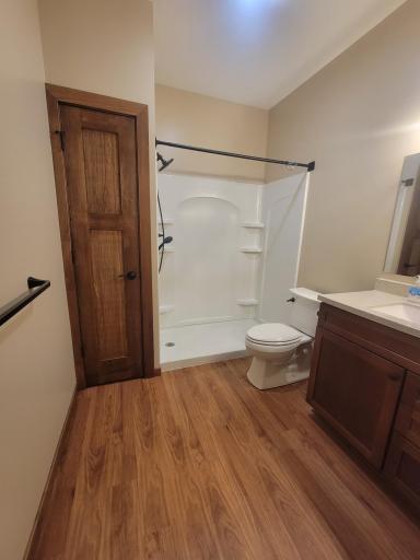 Large bath has walk-in shower and extra storage.