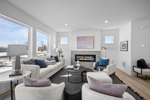 Living room with electric fireplace and large windows
