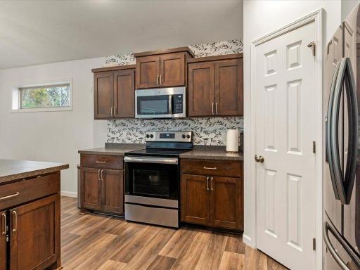 Beautiful quality cabinets with a warm wooden stain and a walk-in pantry