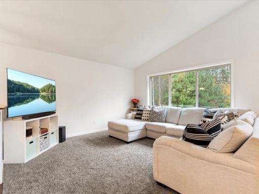 Oversized windows and vaulted ceiling make for a grand open feeling on main level
