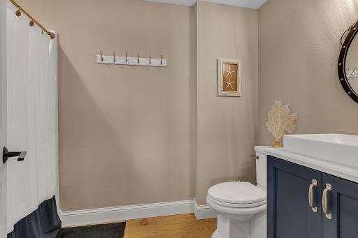 Conveniently located off the lower-level family room, this full bathroom serves both bedrooms and offers easy access for family and guests.