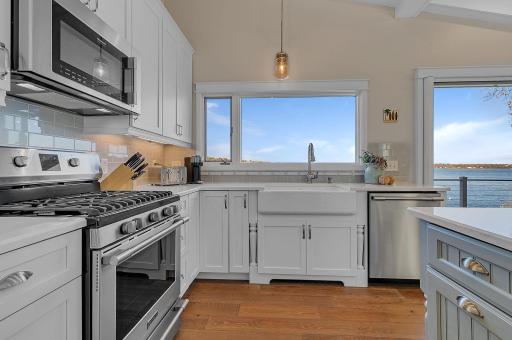 Even doing the dishes comes with a view! The farmhouse-style sink is perfectly positioned beneath a large window overlooking beautiful Lake Sylvia.