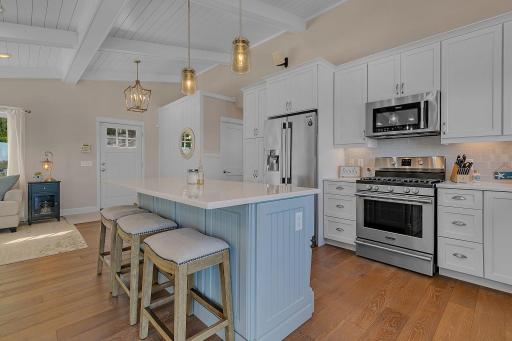 Whether preparing a quick meal or cooking for a crowd, this kitchen is ready with a gas range, stainless steel appliances, and plenty of storage.